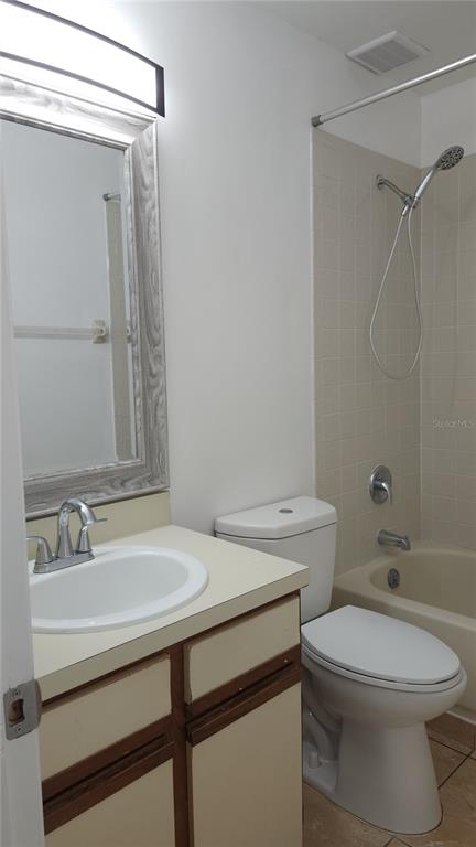 1737 Shady Ridge Court, Unit 231 Orlando, FL 32807 - Photo 17 of 30 a bathroom with a sink a toilet and shower