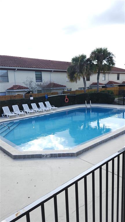 1737 Shady Ridge Court, Unit 231 Orlando, FL 32807 - Photo 4 of 30 a view of a house with a swimming pool