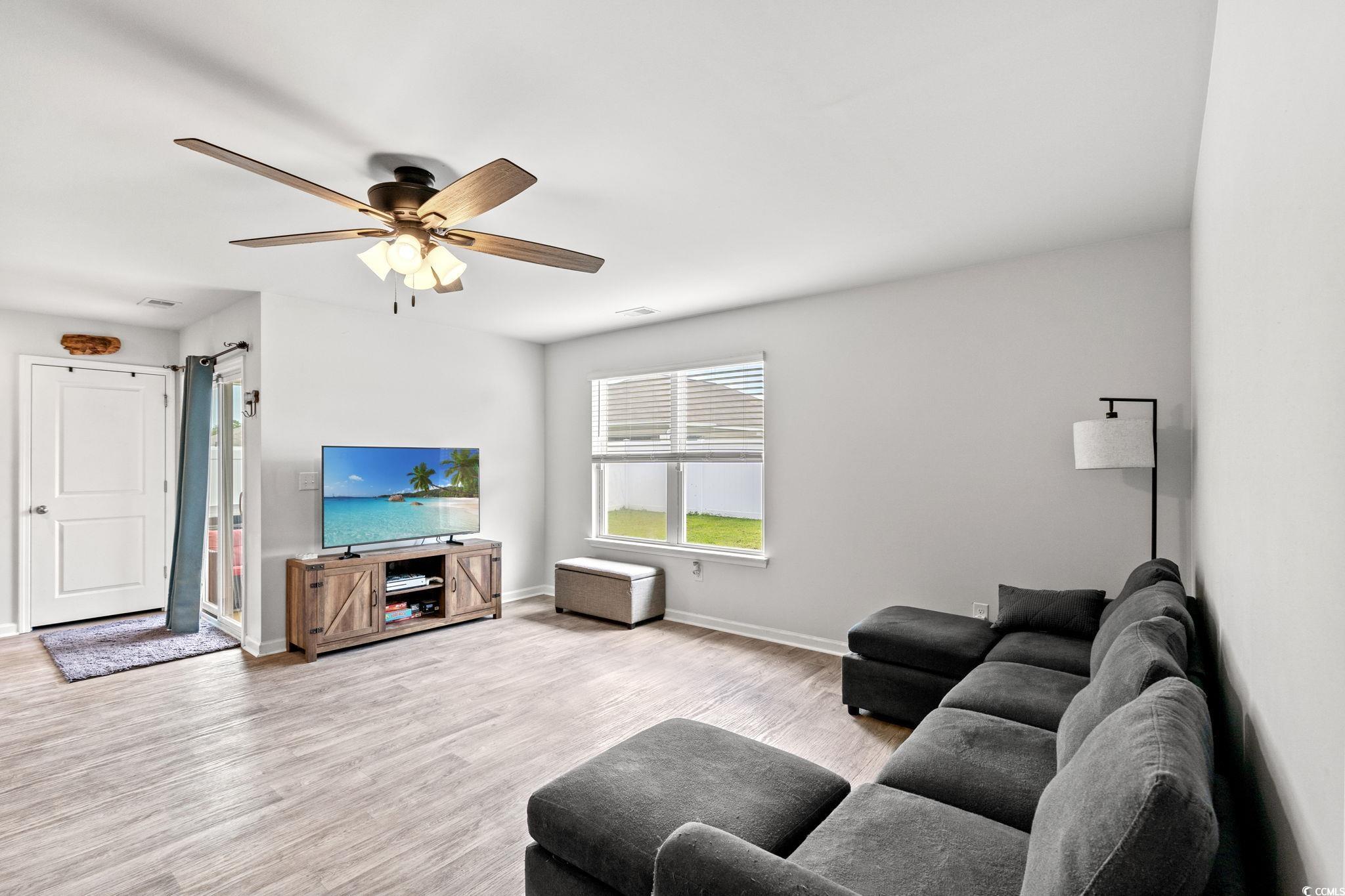 821 Twickenham Loop Longs, SC 29568 - Photo 9 of 35 Living area with wood finished floors and a ceiling fan