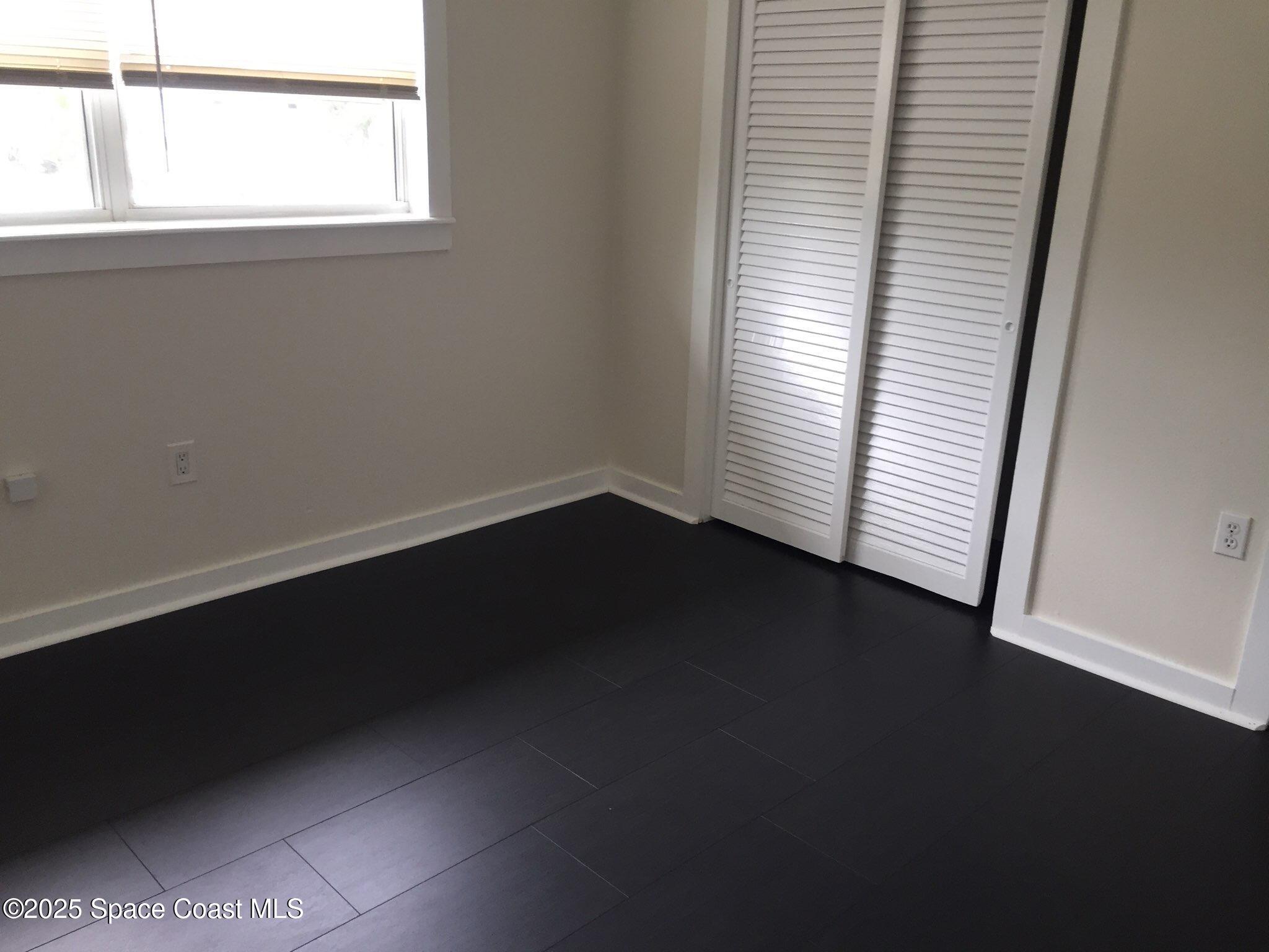 307 Adams Avenue, Unit 14 Cape Canaveral, FL 32920 - Photo 6 of 9 an empty room with a window