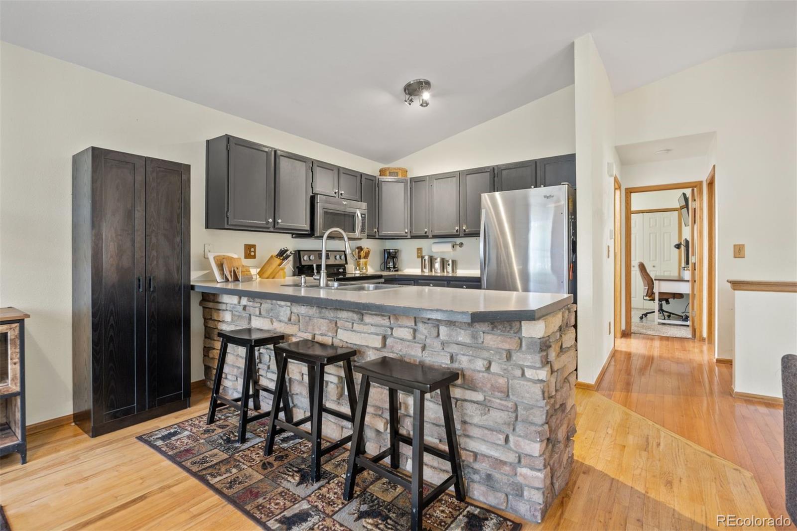 1768 Bluebird Drive Bailey, CO 80421 - Photo 13 of 50 a kitchen with stainless steel appliances granite countertop a refrigerator and a stove top oven