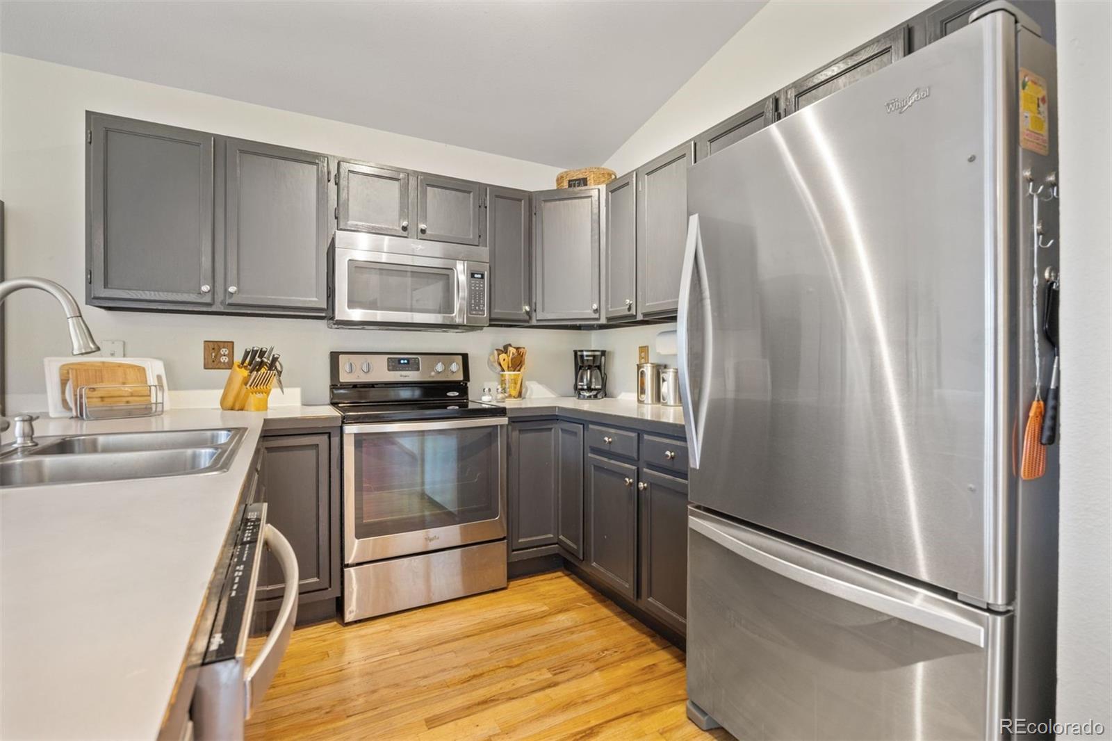 1768 Bluebird Drive Bailey, CO 80421 - Photo 14 of 50 a kitchen with granite countertop a refrigerator and a sink