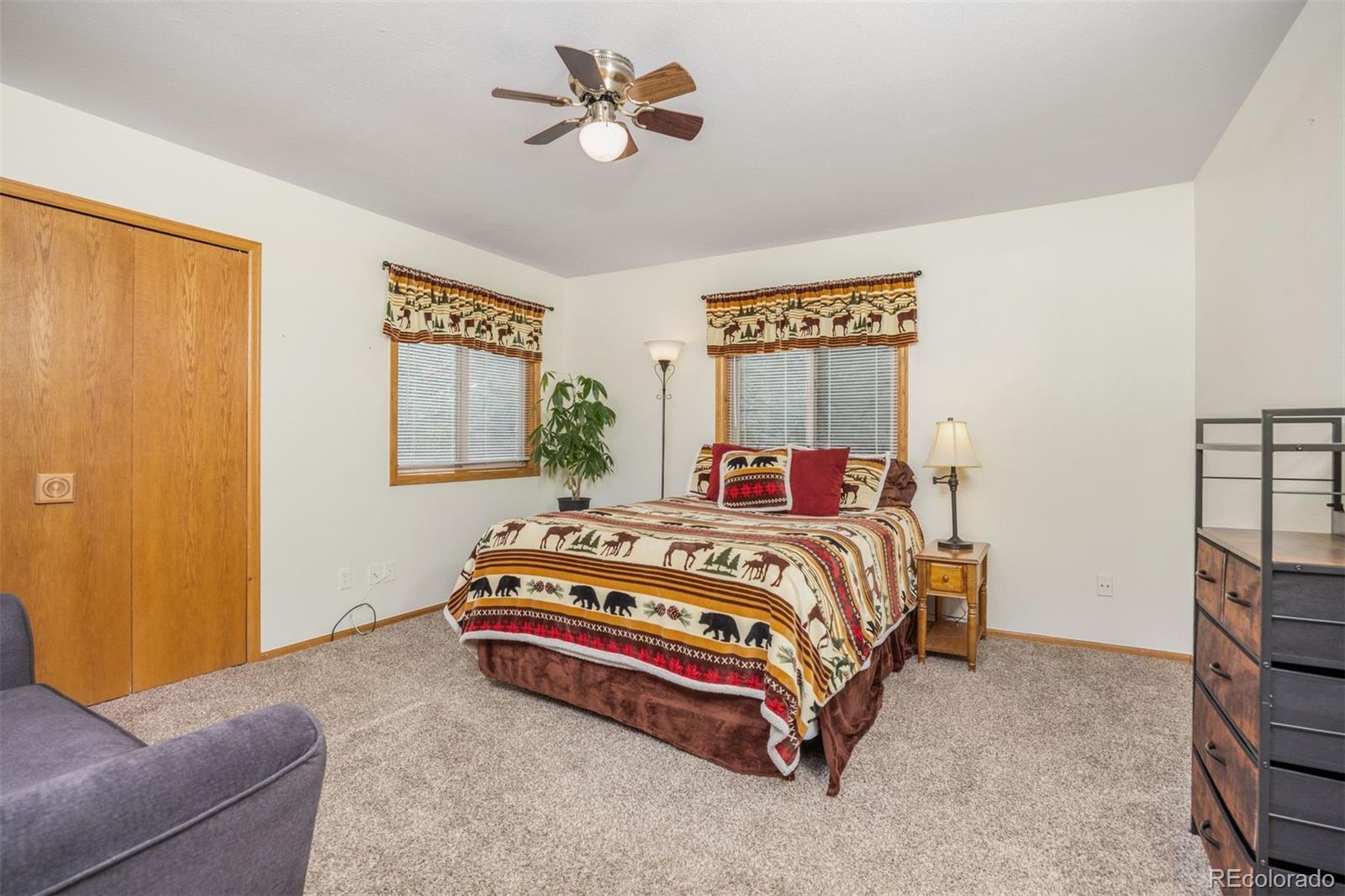 1768 Bluebird Drive Bailey, CO 80421 - Photo 15 of 50 a bedroom with a bed and a chandelier