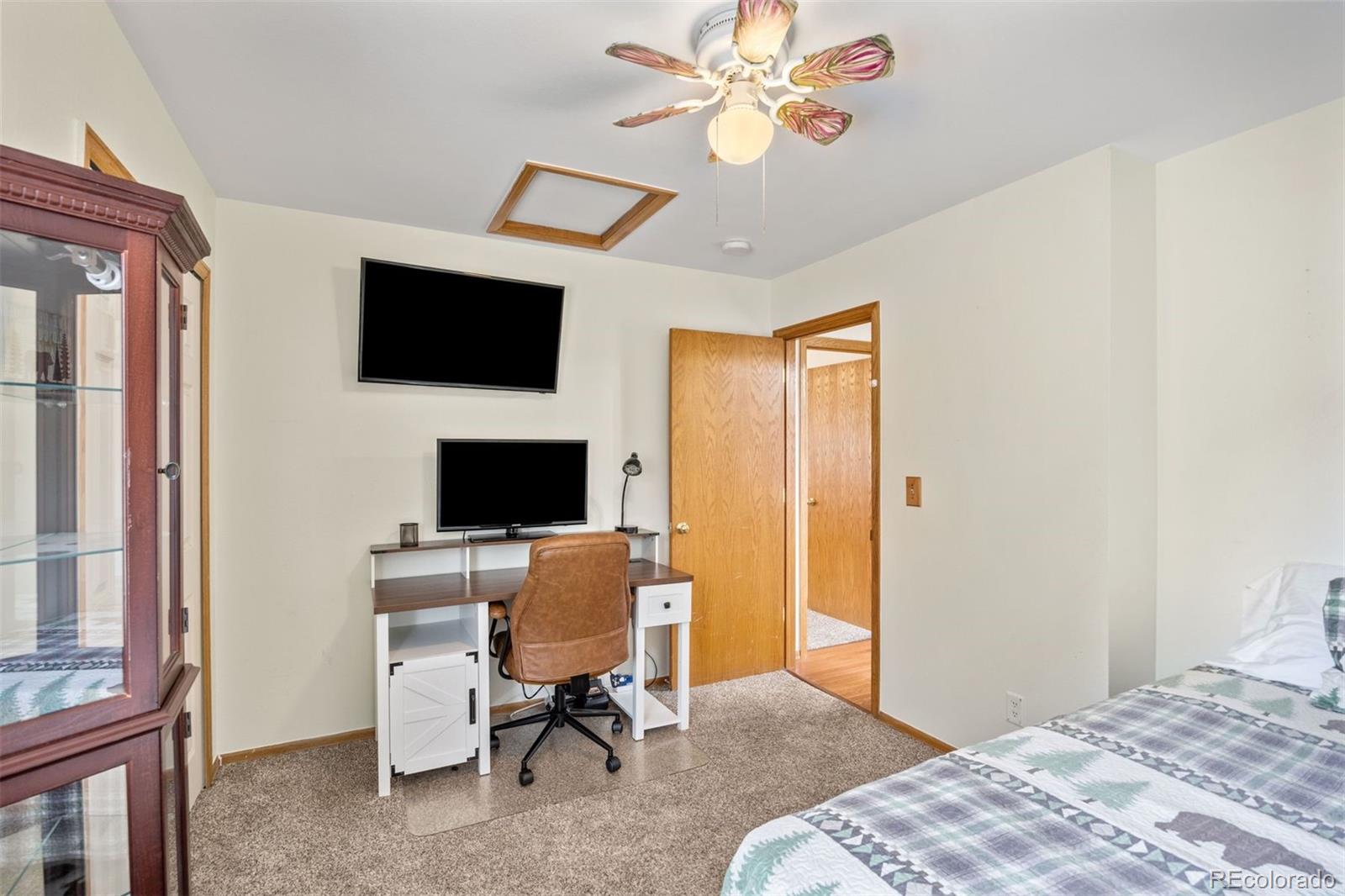 1768 Bluebird Drive Bailey, CO 80421 - Photo 18 of 50 a bedroom with a bed and a flat screen tv