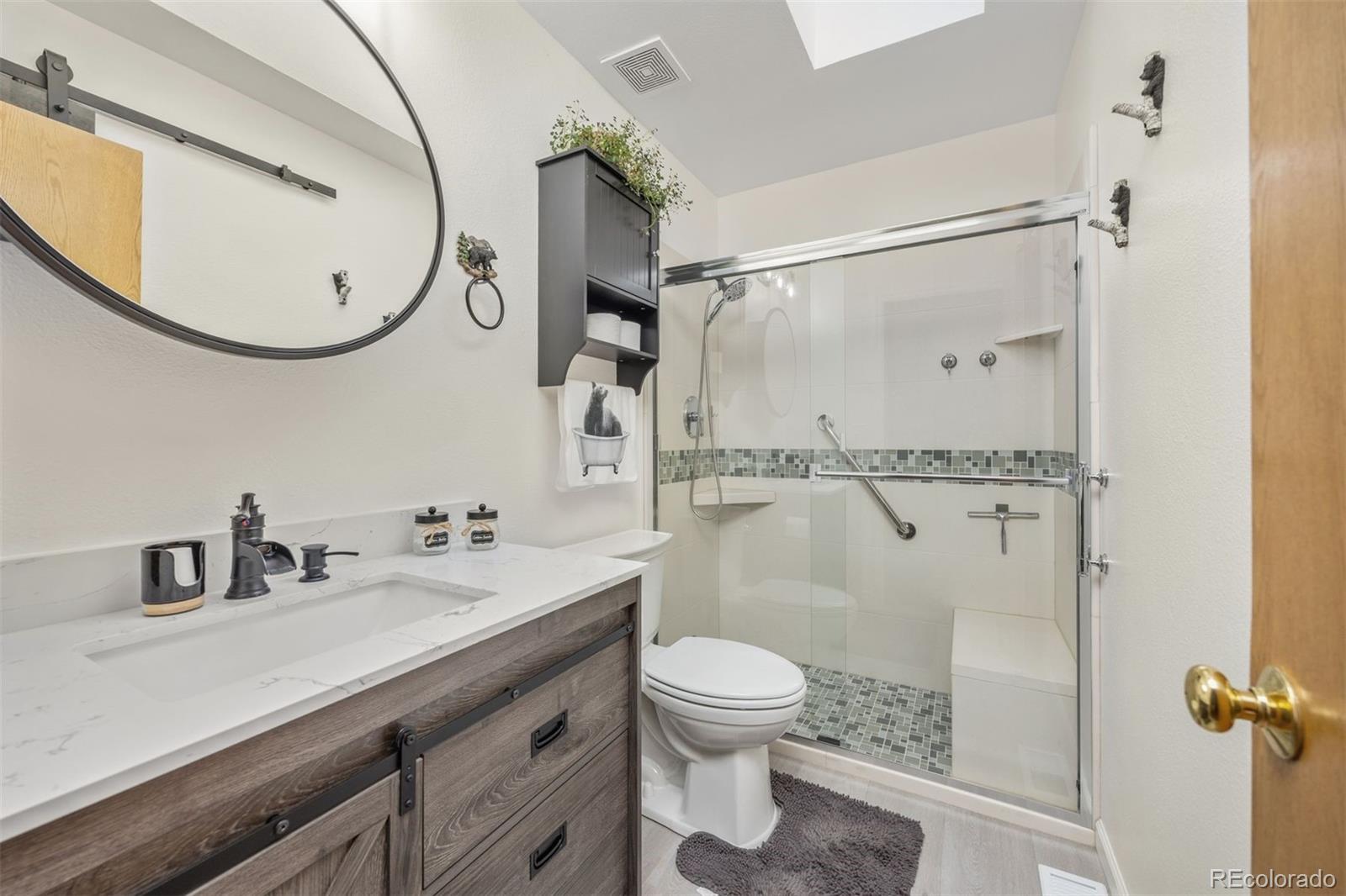 1768 Bluebird Drive Bailey, CO 80421 - Photo 19 of 50 a bathroom with a sink mirror vanity and toilet