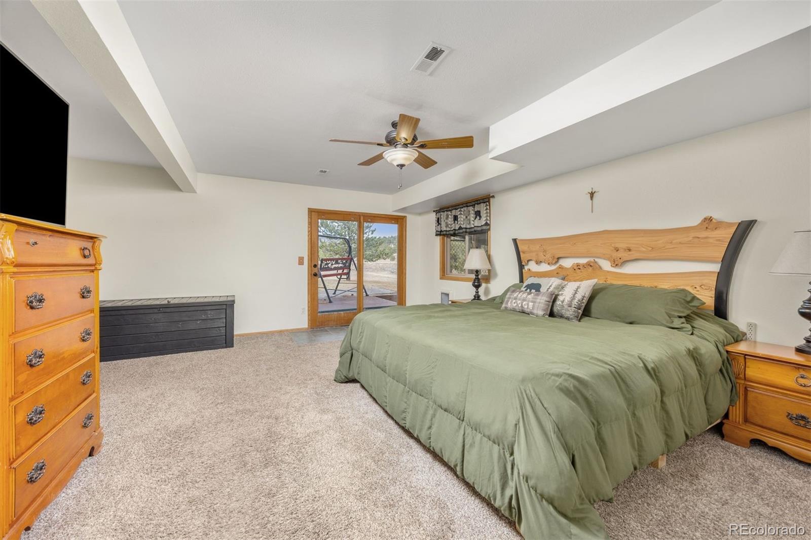 1768 Bluebird Drive Bailey, CO 80421 - Photo 22 of 50 a bedroom with a bed and a flat tv screen on dresser