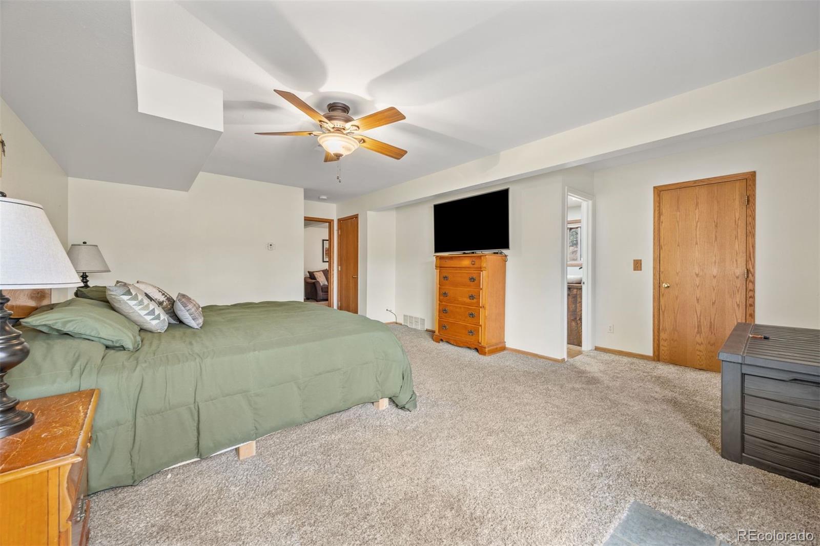 1768 Bluebird Drive Bailey, CO 80421 - Photo 23 of 50 a view of a bedroom with a bed and a chandelier