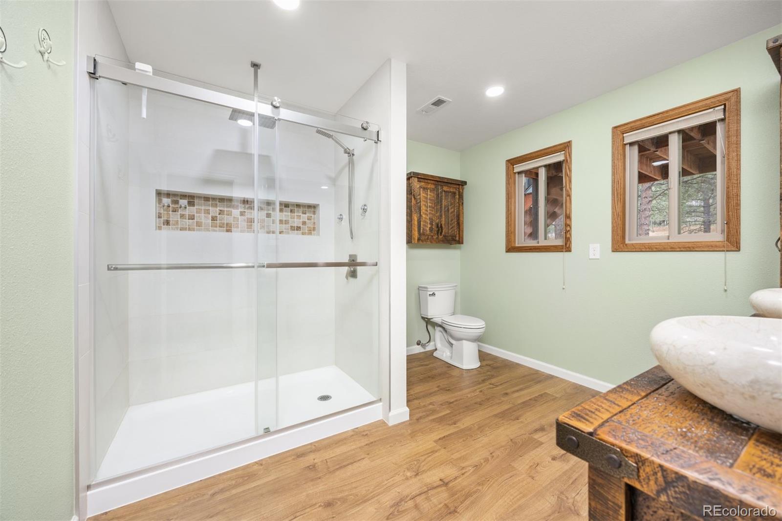 1768 Bluebird Drive Bailey, CO 80421 - Photo 24 of 50 a bathroom with a shower and a sink