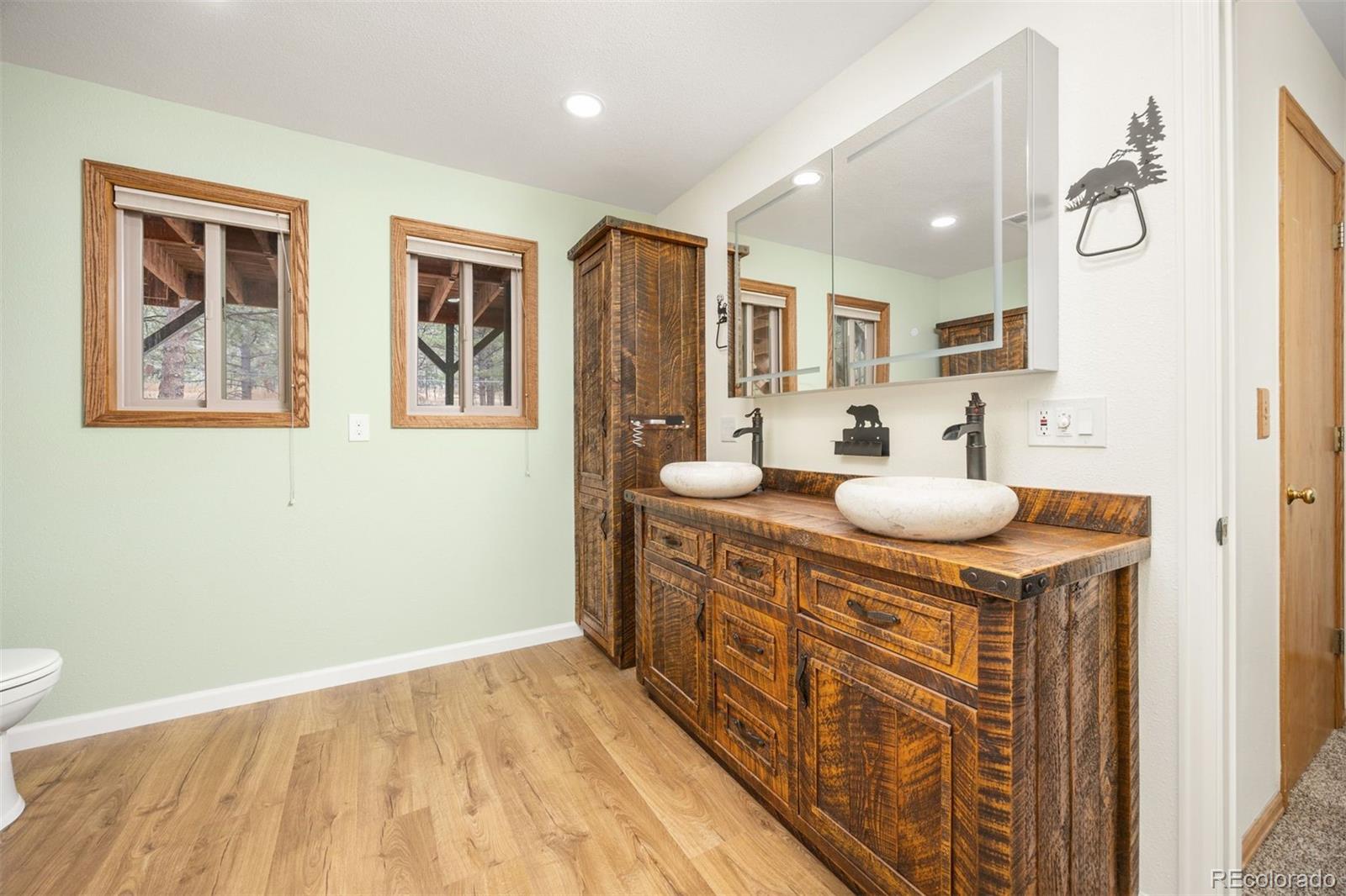 1768 Bluebird Drive Bailey, CO 80421 - Photo 25 of 50 a bathroom with a sink double vanity and a mirror