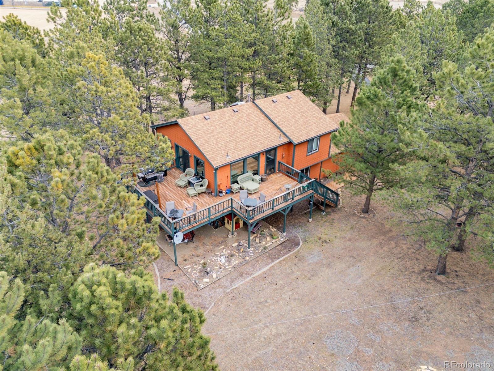 1768 Bluebird Drive Bailey, CO 80421 - Photo 32 of 50 an aerial view of a house with a yard and sitting area