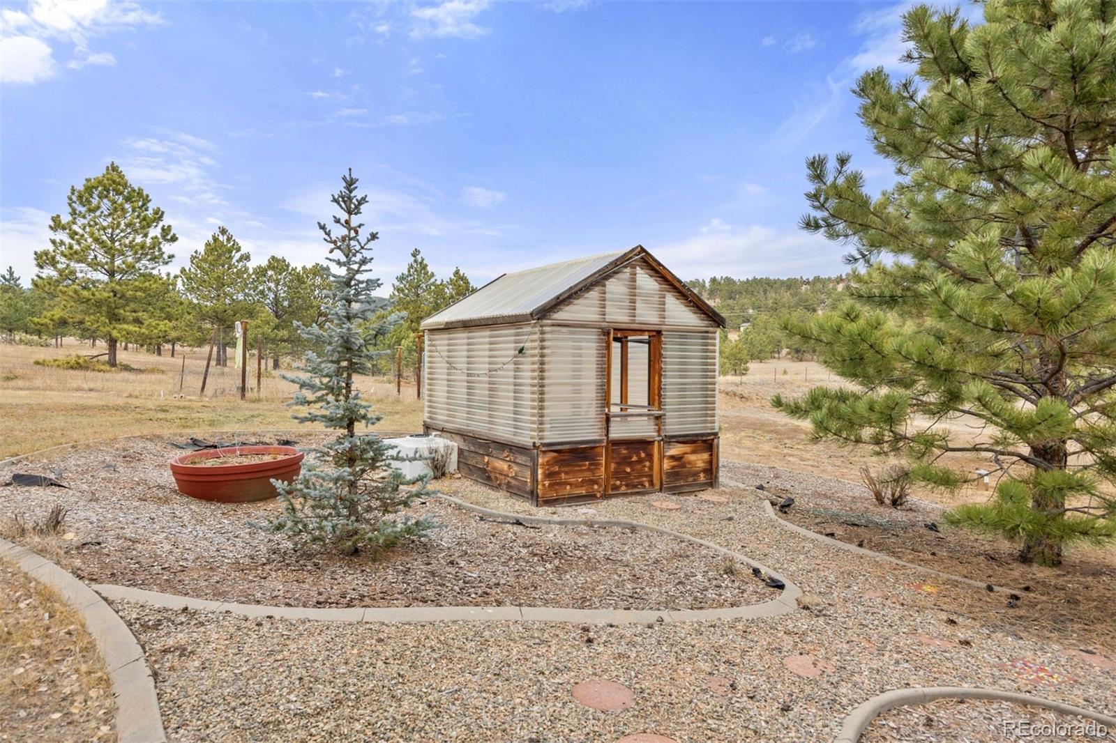 1768 Bluebird Drive Bailey, CO 80421 - Photo 34 of 50 a backyard of a house with outdoor seating