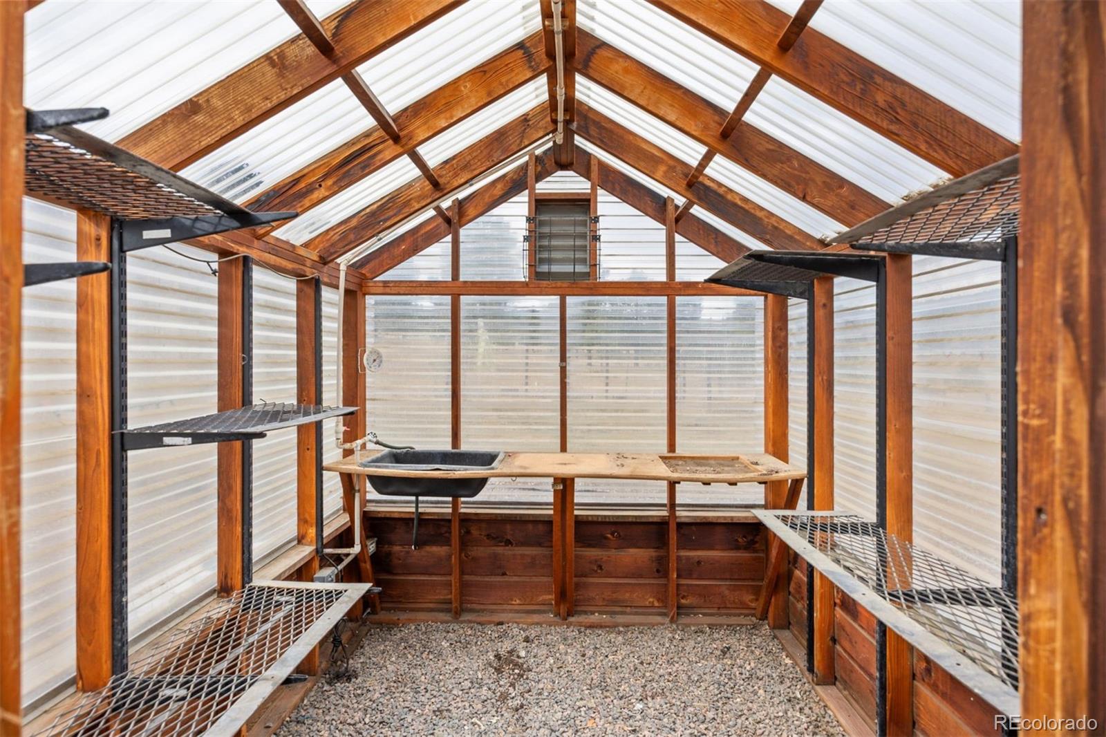 1768 Bluebird Drive Bailey, CO 80421 - Photo 35 of 50 a bedroom with furniture and large windows