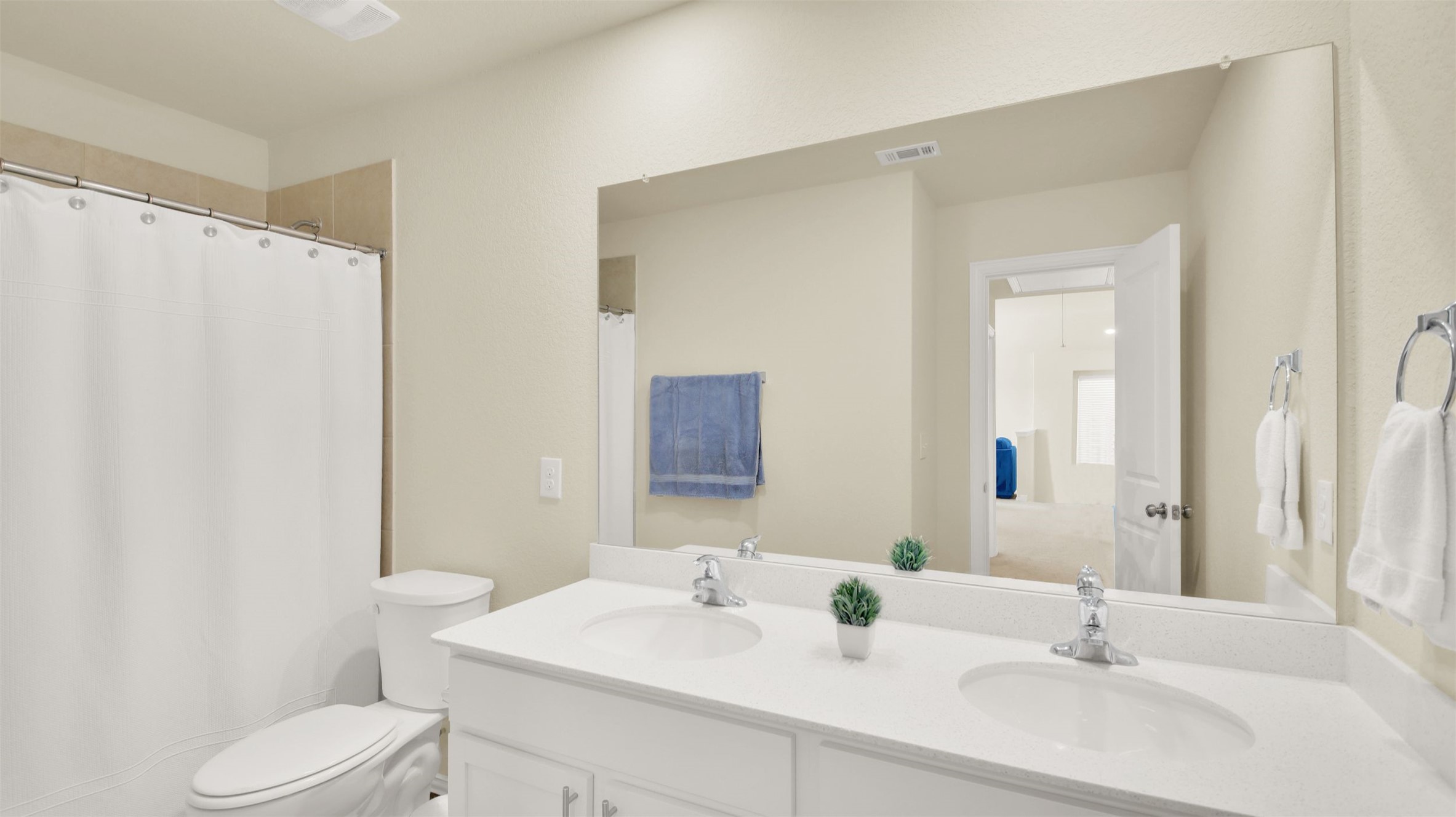 13716 Sugar Bush Path Manor, TX 78653 - Photo 30 of 37 Bathroom featuring double vanity and a shower with curtain