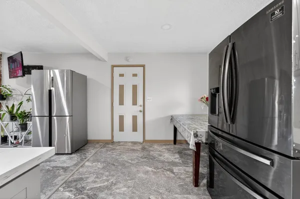 a kitchen with a refrigerator and a refrigerator