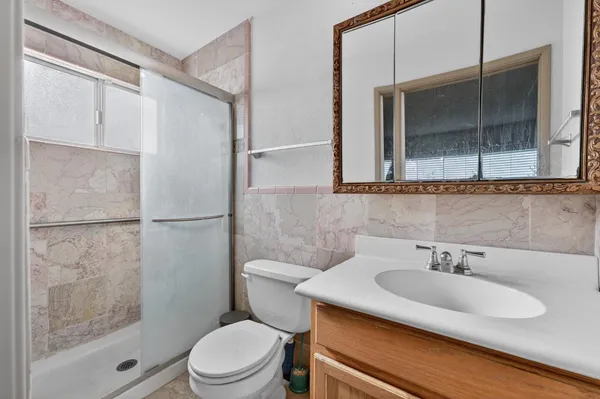 a bathroom with a sink toilet and shower