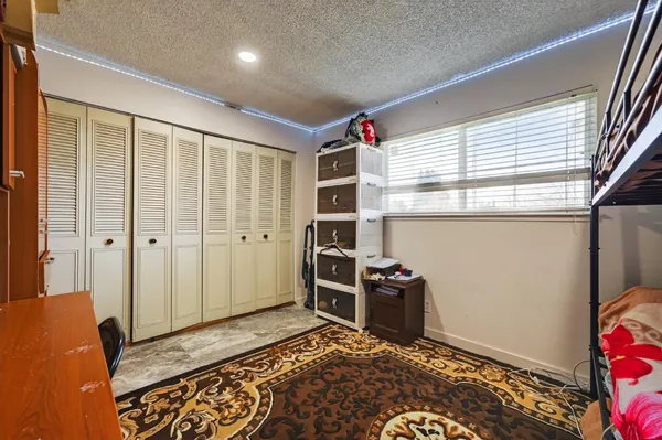 a view of a bedroom with bed and wooden floor