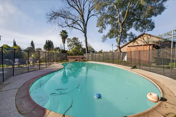 a view of a swimming pool with a patio