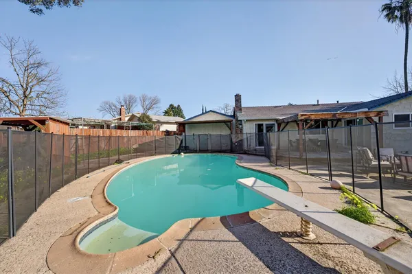 a view of a house with backyard and sitting area