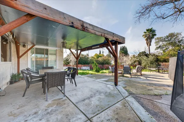 a view of a park with bench sitting area