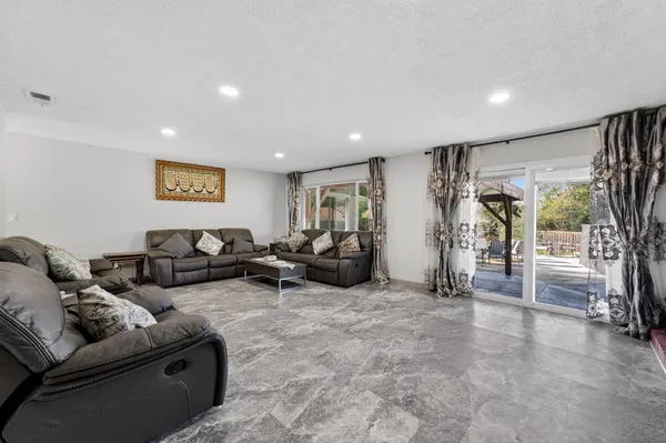 a living room with furniture and a gym machine