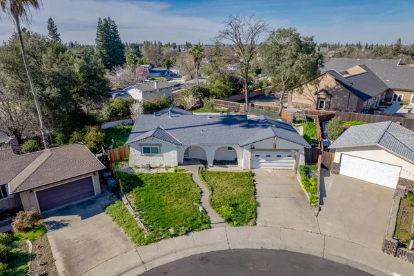 an aerial view of a house with garden space and street view