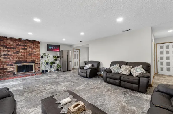 a living room with furniture a fireplace and a fireplace
