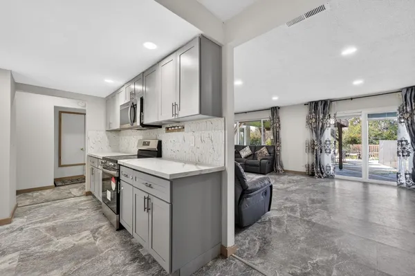 a kitchen with a sink stove and cabinets