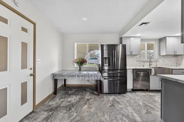 a kitchen with stainless steel appliances a refrigerator sink and stove
