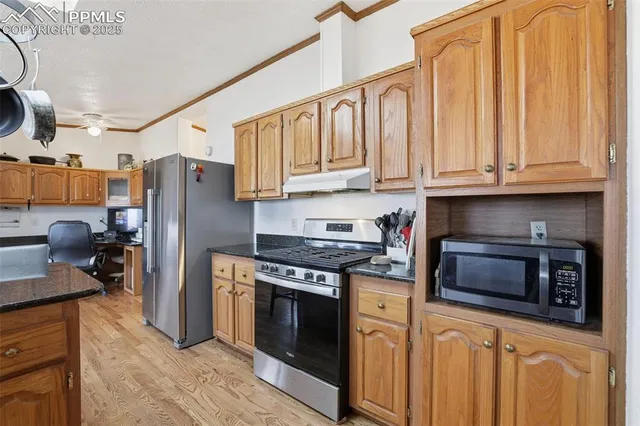 a kitchen with stainless steel appliances granite countertop a stove a refrigerator and a granite counter tops
