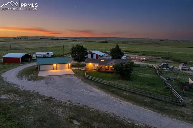 an aerial view of a house with a yard basket ball court