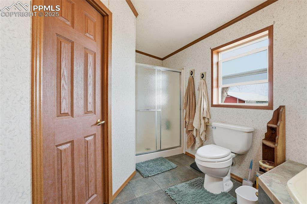 9235 Guthrie Road Calhan, CO 80808 - Photo 23 of 49 a bathroom with a toilet and a shower