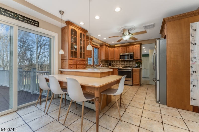 421 Adamic Hill Road Milford, NJ 08848 - Photo 15 of 45 a dining hall with stainless steel appliances granite countertop a refrigerator and a stove top oven