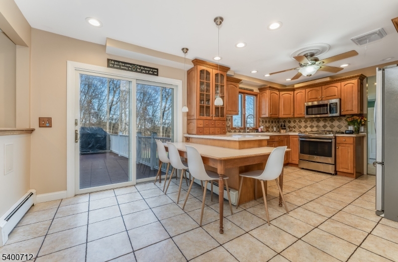 421 Adamic Hill Road Milford, NJ 08848 - Photo 16 of 45 a dining hall with stainless steel appliances a dining table and chairs