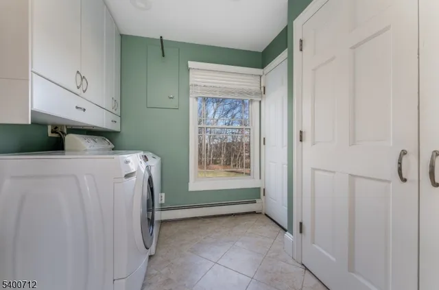 a view of a utility room with closet empty shelves and wooden floor