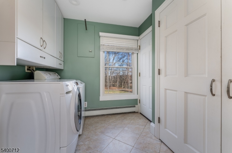 421 Adamic Hill Road Milford, NJ 08848 - Photo 18 of 45 a view of a utility room with closet empty shelves and wooden floor
