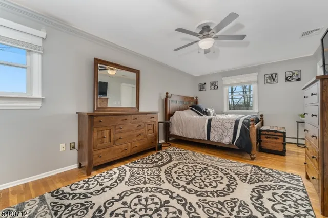 a bedroom with a bed and dresser with mirror