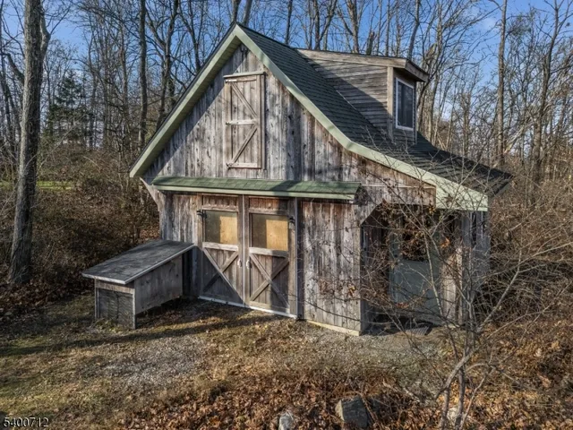 a view of a house with a yard and wooden fence
