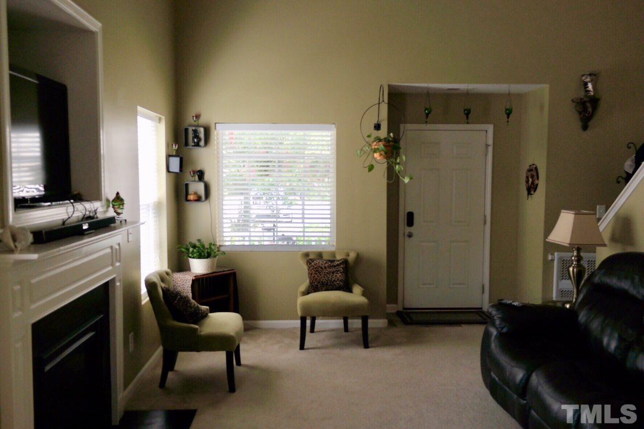1012 Lombar Street Raleigh, NC 27610 - Photo 12 of 20 a living room with furniture a fireplace and a flat screen tv