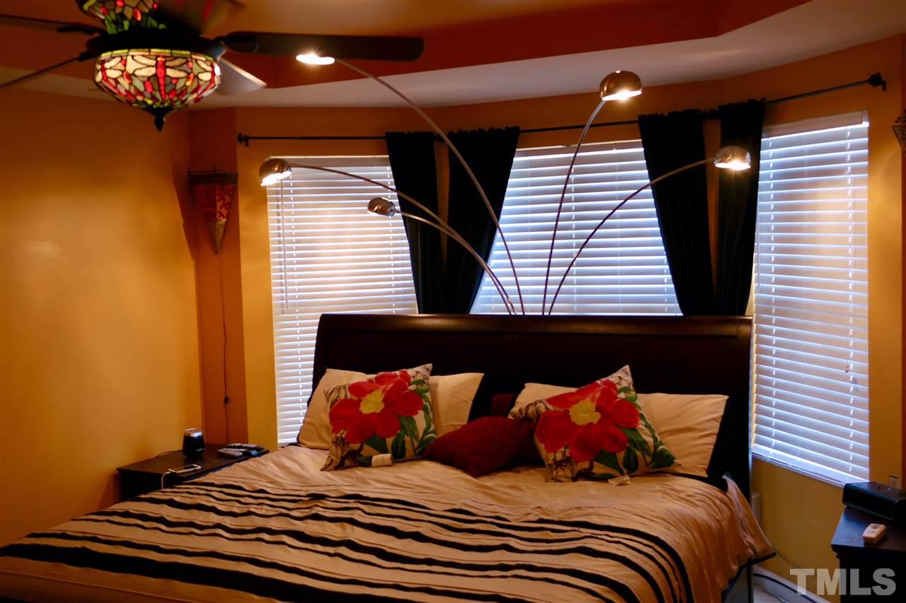 1012 Lombar Street Raleigh, NC 27610 - Photo 15 of 20 a bedroom with a bed and a night stand