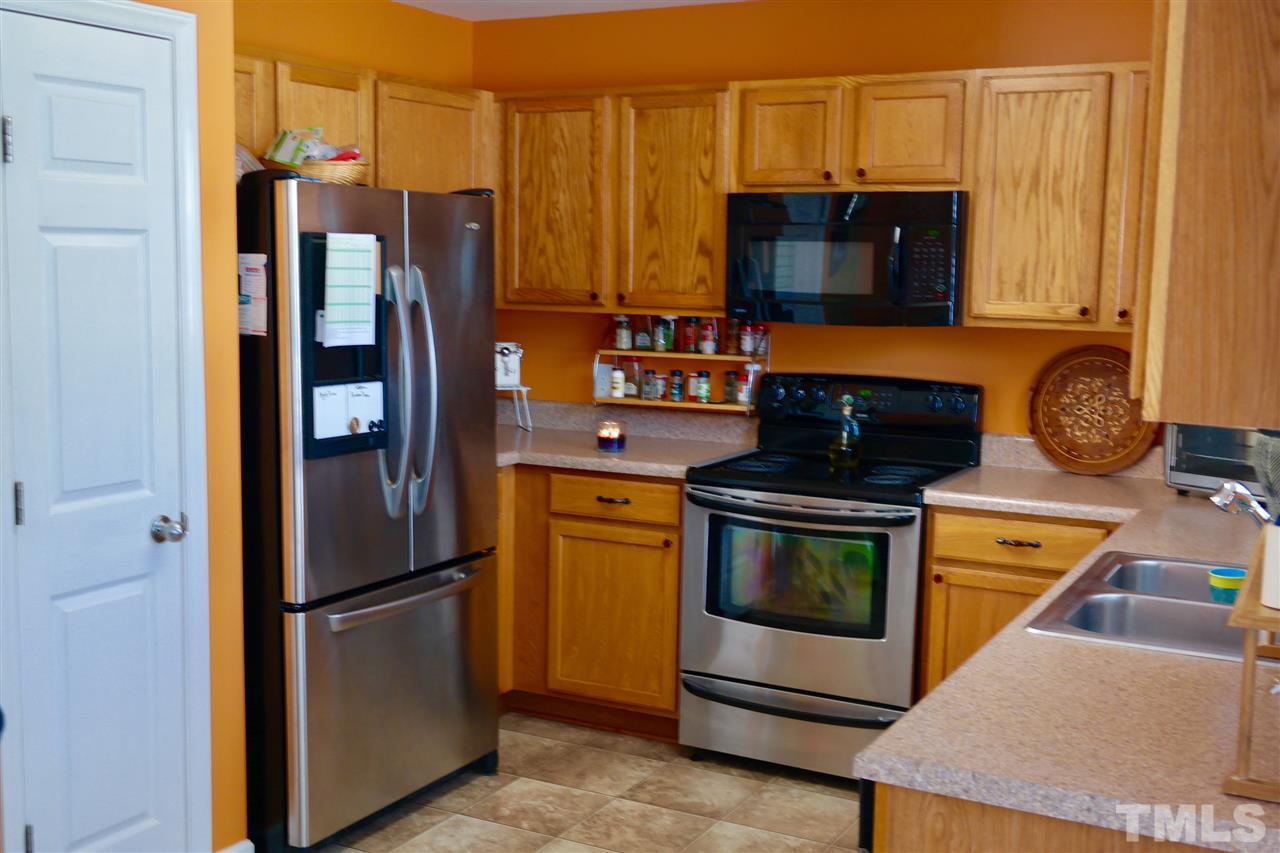 1012 Lombar Street Raleigh, NC 27610 - Photo 9 of 20 a kitchen with stainless steel appliances granite countertop a refrigerator stove and microwave