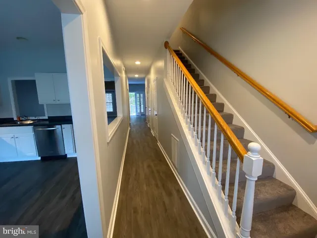 a kitchen with a refrigerator a stove top oven a sink and dishwasher