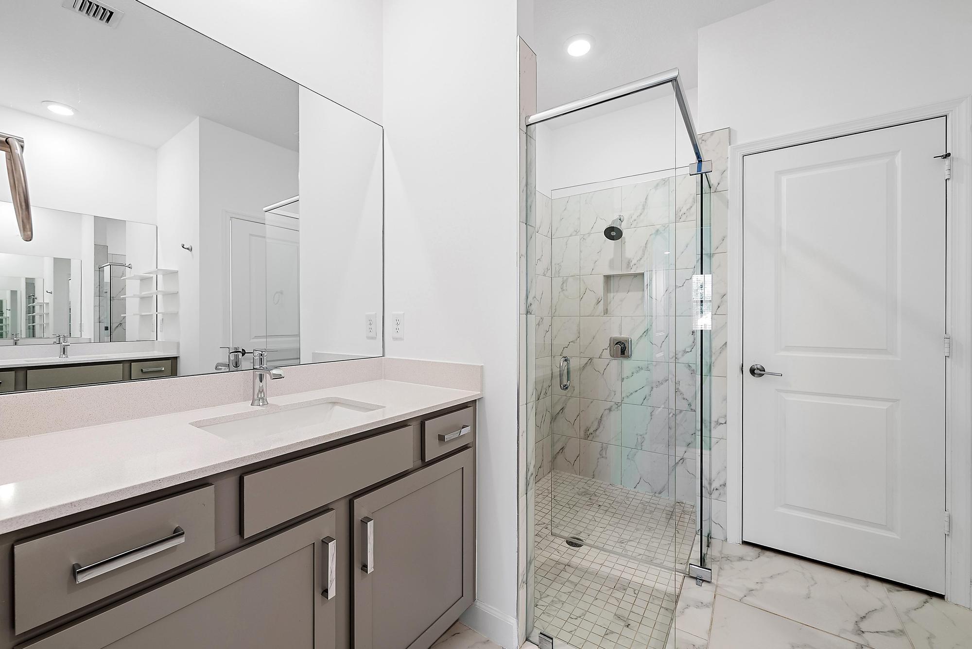 1283 Tangled Orch Trace Loxahatchee, FL 33470 - Photo 12 of 21 a bathroom with a shower sink and mirror