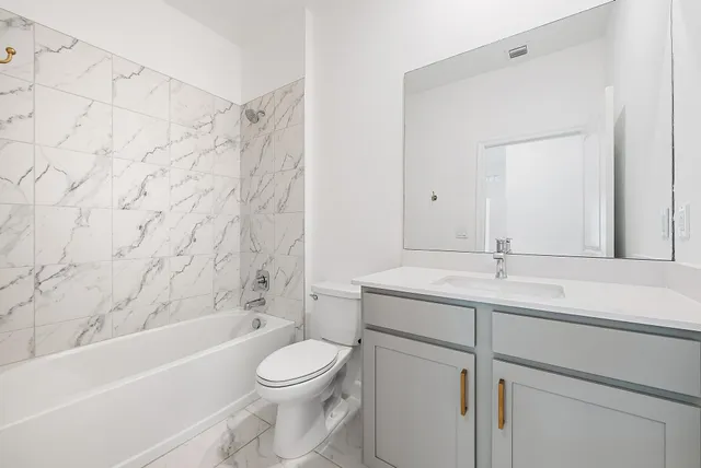 a bathroom with a sink a toilet and a bathtub