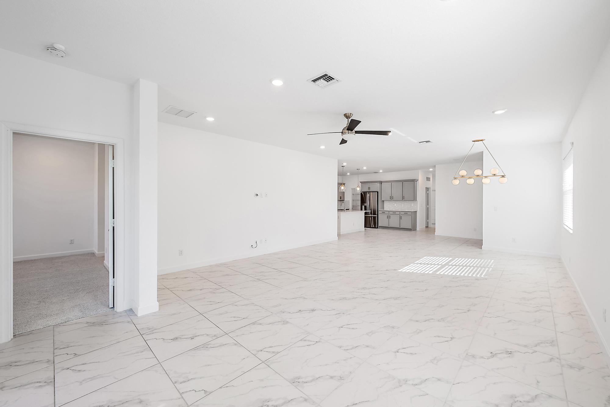 1283 Tangled Orch Trace Loxahatchee, FL 33470 - Photo 6 of 21 an empty room with kitchen and windows