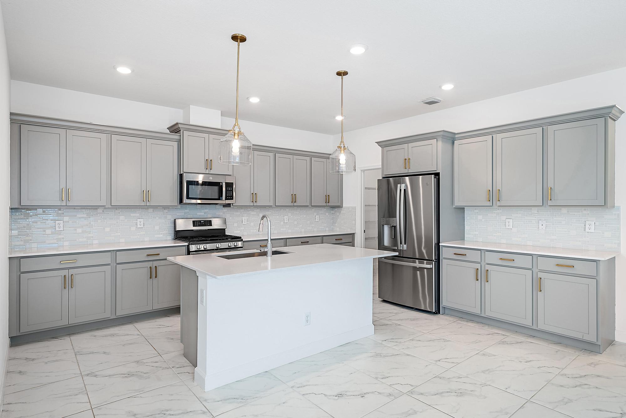 1283 Tangled Orch Trace Loxahatchee, FL 33470 - Photo 7 of 21 a kitchen with kitchen island granite countertop cabinets and stainless steel appliances