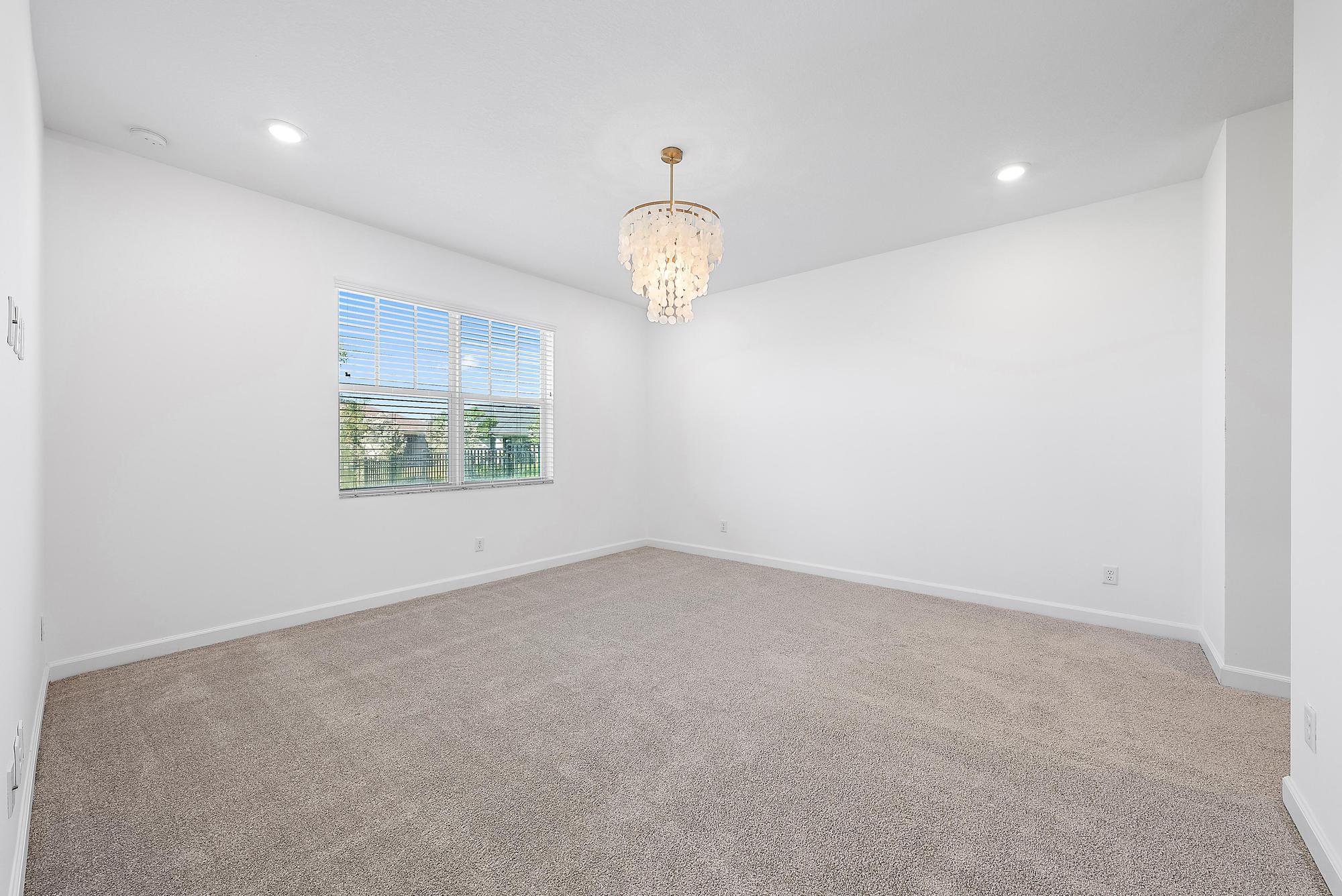 1283 Tangled Orch Trace Loxahatchee, FL 33470 - Photo 9 of 21 an empty room with windows and ceiling fan