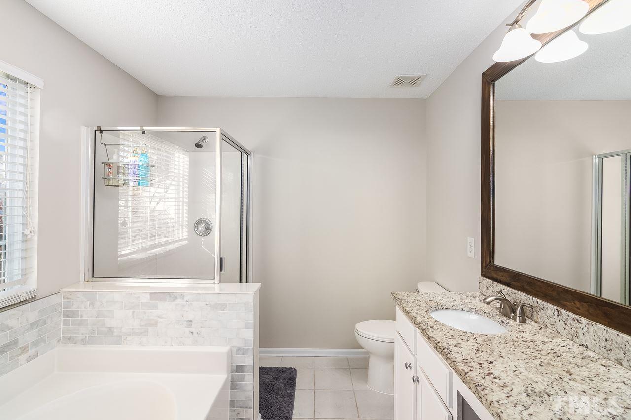 8 Sharpstone Lane Durham, NC 27703 - Photo 11 of 15 a bathroom with a granite countertop sink and a mirror