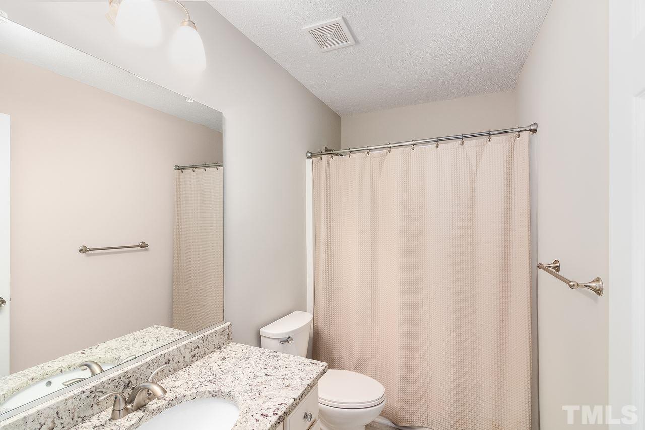 8 Sharpstone Lane Durham, NC 27703 - Photo 12 of 15 a bathroom with a sink and curtain
