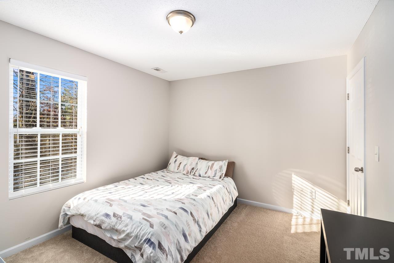 8 Sharpstone Lane Durham, NC 27703 - Photo 13 of 15 a bedroom with a bed and a window