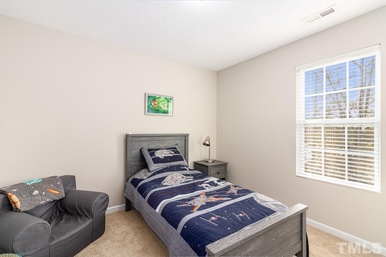 8 Sharpstone Lane Durham, NC 27703 - Photo 14 of 15 a bedroom with a bed and a couch